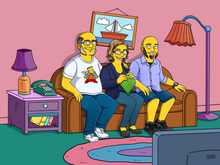 Load image into Gallery viewer, The Simpsons family portrait a couple and their son sitting on a couch, man is wearing glasses and a bart simpsons shirt and woman is sewing something.