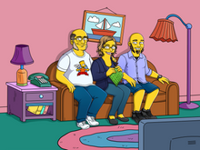 Load image into Gallery viewer, The Simpsons family portrait a couple and their son sitting on a couch, man is wearing glasses and a bart simpsons shirt and woman is sewing something.
